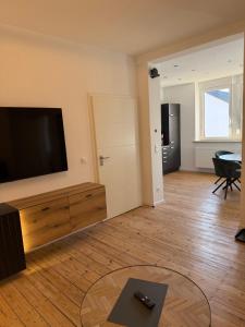 a living room with a flat screen tv on a wall at Ferienwohnung Hildegard in Clausen