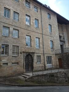 a large brick building with a large door at O'Couvent - Appartement 131 - 2 chambres - 90 m2 - Troisième étage in Salins-les-Bains