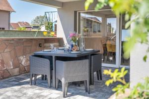 a black table and chairs on a patio at Logement "Le Vôl des cigognes" in Baldenheim