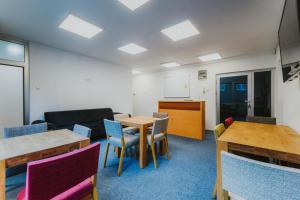 a meeting room with tables and chairs and a whiteboard at Hostel Rio in Sarajevo