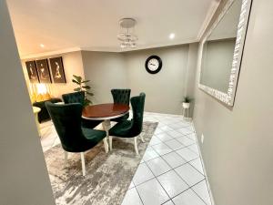 une salle à manger avec une table et des chaises vertes dans l'établissement The Chapel Luxury Apartments 2, à Johannesbourg