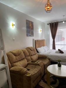 a living room with a couch and a bed at Near JKIA tsavo fedha in Nairobi