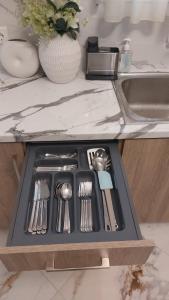 a drawer filled with utensils on a kitchen counter at Luxury Maisonette in Ioannina