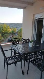 a black table and chairs on a balcony with a view at Luxury Maisonette in Ioannina