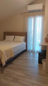 a bedroom with a bed and a large window at Luxury Maisonette in Ioannina +31 photos