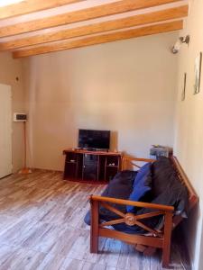 a bedroom with a bed and a wooden floor at Casas de montañas in Uspallata