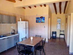 a kitchen with a table and chairs and a refrigerator at Casas de montañas in Uspallata