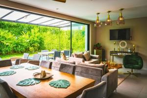 a living room with a table and a large window at Maison Eden in Armenia