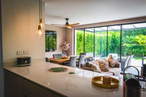 a kitchen and living room with a large window at Maison Eden in Armenia