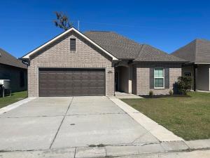 a house with a brown garage at Da Weezy-Ana House in Houma