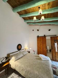 a bedroom with a bed and a wooden ceiling at La Antigua Estación - Río Mundo Agramón in Agramón +31 photos
