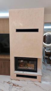 a fireplace sitting on top of a marble floor at Luxury Maisonette in Ioannina