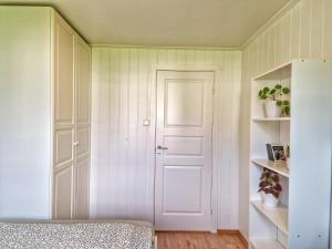 a bedroom with a white door and a bed at Private Room in a shared Apartment with Mountain Views & Greenery in Trondheim