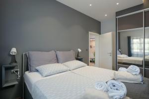 a bedroom with a large bed with towels on it at Villa Kadore in Višnjan +42 photos