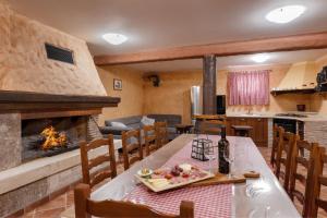 a living room with a table and a fireplace at Villa Kadore in Višnjan