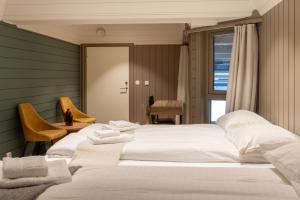 a bedroom with two beds with towels on them at Villa Oleanna in Lysekloster