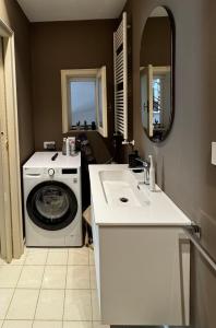 a bathroom with a washing machine and a sink at Apulian Green Leaves House in Giovinazzo +13 photos
