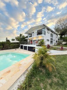 a house with a swimming pool in front of a house at Villa Verde in Silvania