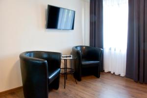 Telewizja i/lub zestaw kina domowego w obiekcie Apartamenty Hotelu Pod Orłem