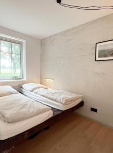 two beds in a room with a window at Deine Ruhe Oase mit Waldblick in Gustow