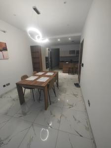 a dining room with a table and a wall at Carina Mansion in Birżebbuġa +3 photos