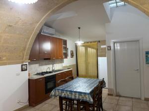 a kitchen with a table with a table cloth on it at La payara di nonna nina in Tiggiano