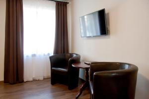 Telewizja i/lub zestaw kina domowego w obiekcie Apartamenty Hotelu Pod Orłem