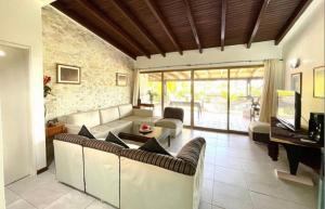 a living room with couches and a piano at Beach House Terrazas de Guacuco isla de Margarita in Playa Guacuco