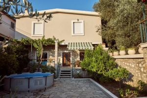 a house with a hot tub in front of it at Apartments "Old house Mustafic" in Bar