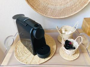 a hair dryer sitting on a table next to baskets at Casita El Lobo in Montech