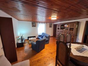 a living room with a couch and a table at Casa de Cabecinho- Albufeira do Azibo in Bragança
