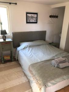a large bed in a bedroom with a window at Agape in Vailhourles