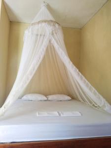 Ένα ή περισσότερα κρεβάτια σε δωμάτιο στο Rima Homestay