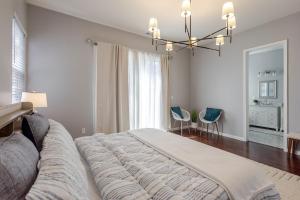 a bedroom with a large bed and a chandelier at New Reno Retreat 72 Inch TV Office Patio Views in Reno