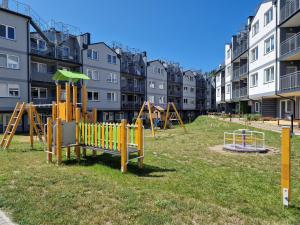a playground in a park in front of buildings at Mario Leśny Klif 21 in Debina