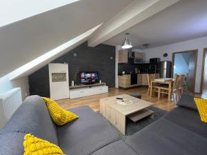 a living room with a couch and a table at Apartment Loft Fifteen in Dunajská Streda