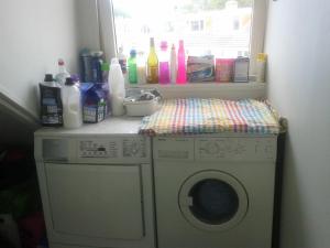 a washing machine in a room with a window at Charming Family Home in Delft