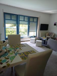 a living room with a table and chairs and a couch at FeWo Oberhof - Tiefgarage und Parkplatz inklusive in Oberhof
