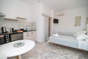 a small room with a bed and a table in it at Thines studio B in Kefalos
