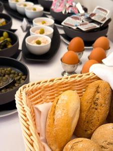a basket of bread and eggs on a table at Kalix Boutique Hotel in Poprad