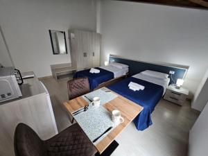 a hotel room with two beds and a table at Mare Fuori in Gonnesa