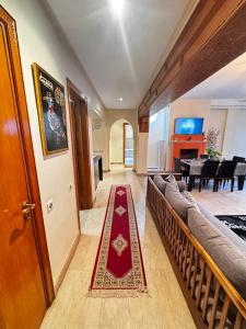 a living room with a couch and a red carpet at Dar Fayz in Marrakesh