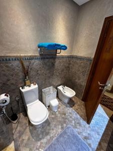 a bathroom with a toilet and a sink at Dar Fayz in Marrakesh +9 photos