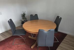 a wooden table and chairs in a room at Rooms ETVY, Tv AC in Ulcinj