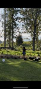 a girl is playing with a frisbee in the grass at Fiery Peak Glampsite with Stargazing & Hot Tub in Geraldine