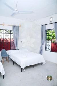 a white bedroom with a large bed and windows at Casa Vainilla - Privacy, Best For Families, Tecolutla in Tecolutla