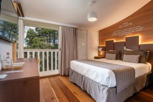 a bedroom with a large bed and a balcony at Casa Sabor Chocolate in Campos do Jordão