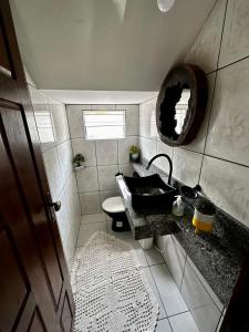 a bathroom with a sink and a mirror at Casa em Alter do chão - lago verde in Alter do Chao +58 photos