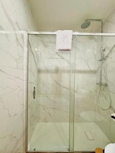 a shower with a glass door in a bathroom at Old Porto - Tiny House & Apartment Luxury Garden by MyMoradia in Porto +35 photos