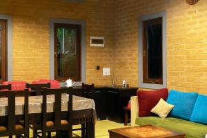 a living room with a couch and a table at Windy Hills Glamping in Belihuloya